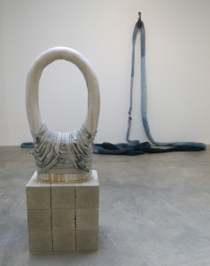 Anna Sew Hoy, Woven Void, glazed stoneware, denim, cinder blocks, 44 x 23 x 5 inches, 2016 in front of Denim Worm, jeans, cotton t-shirts, thread, 1,260 inches (continuous loop), 2016.