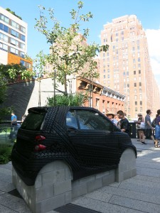 Nari Ward, Smart Tree, Smart car, cinder blocks, tire treads, soil, apple tree, 106 x 61 x 120 inches, 2016.